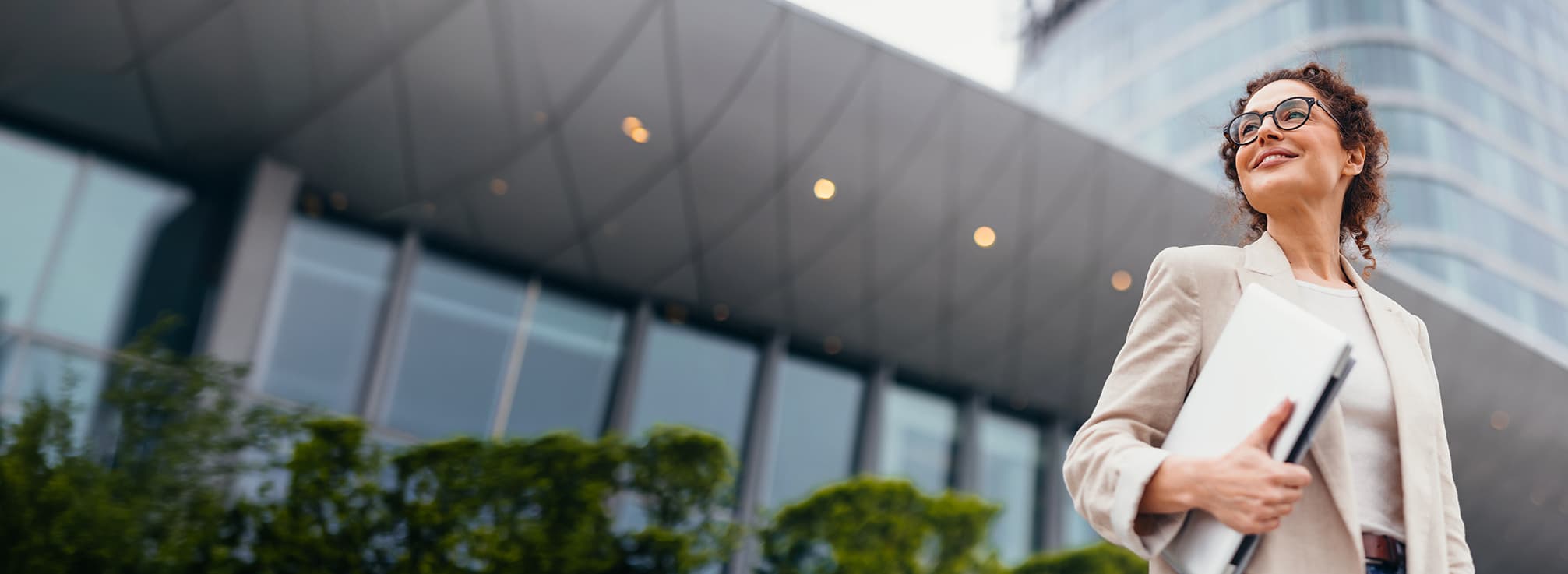 A business professional outside a modern office building